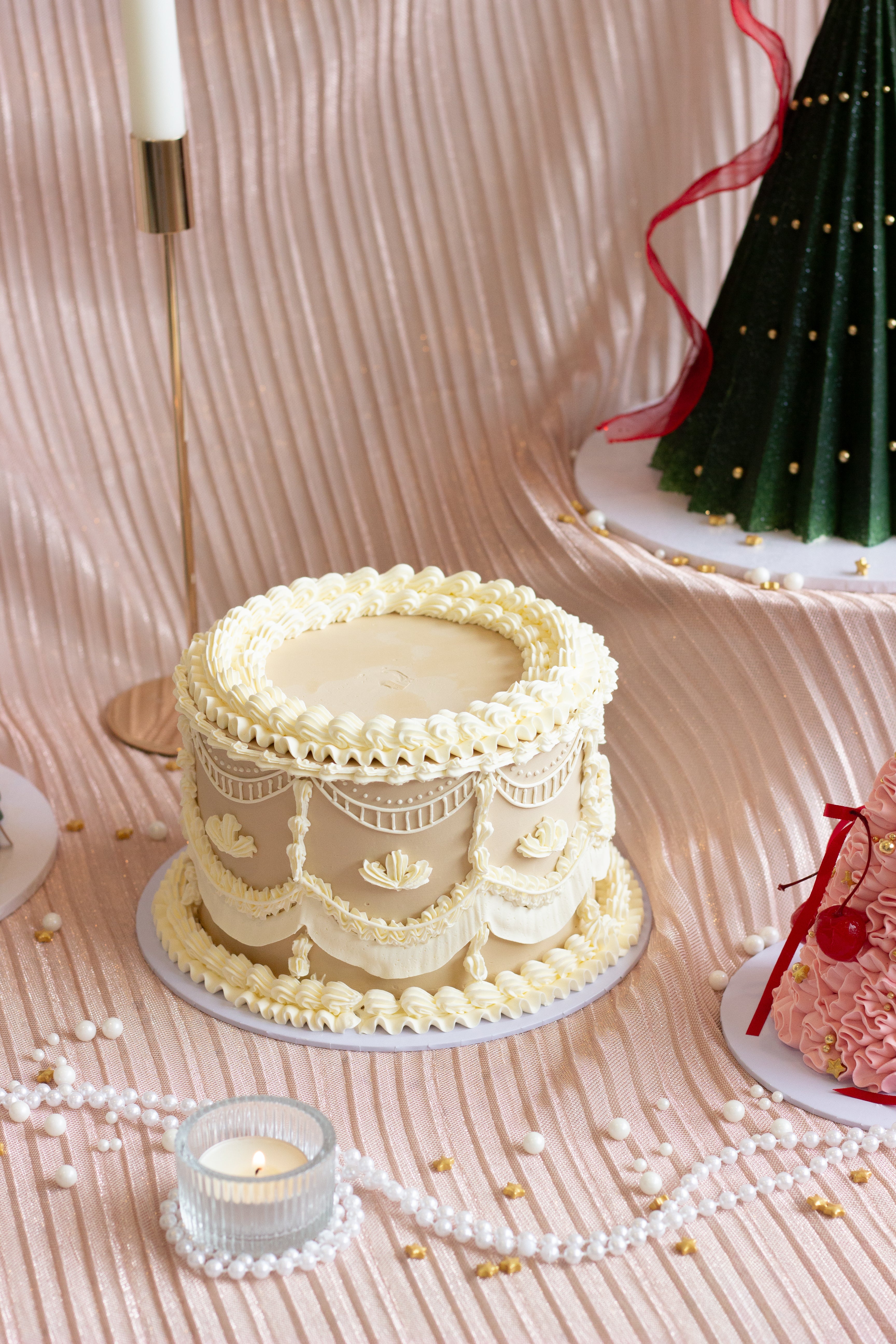 Ivory buttercream cake with detailed vintage piping, swags, and lace style borders. Gingerbread cookie inspired cake. Cake Melbourne