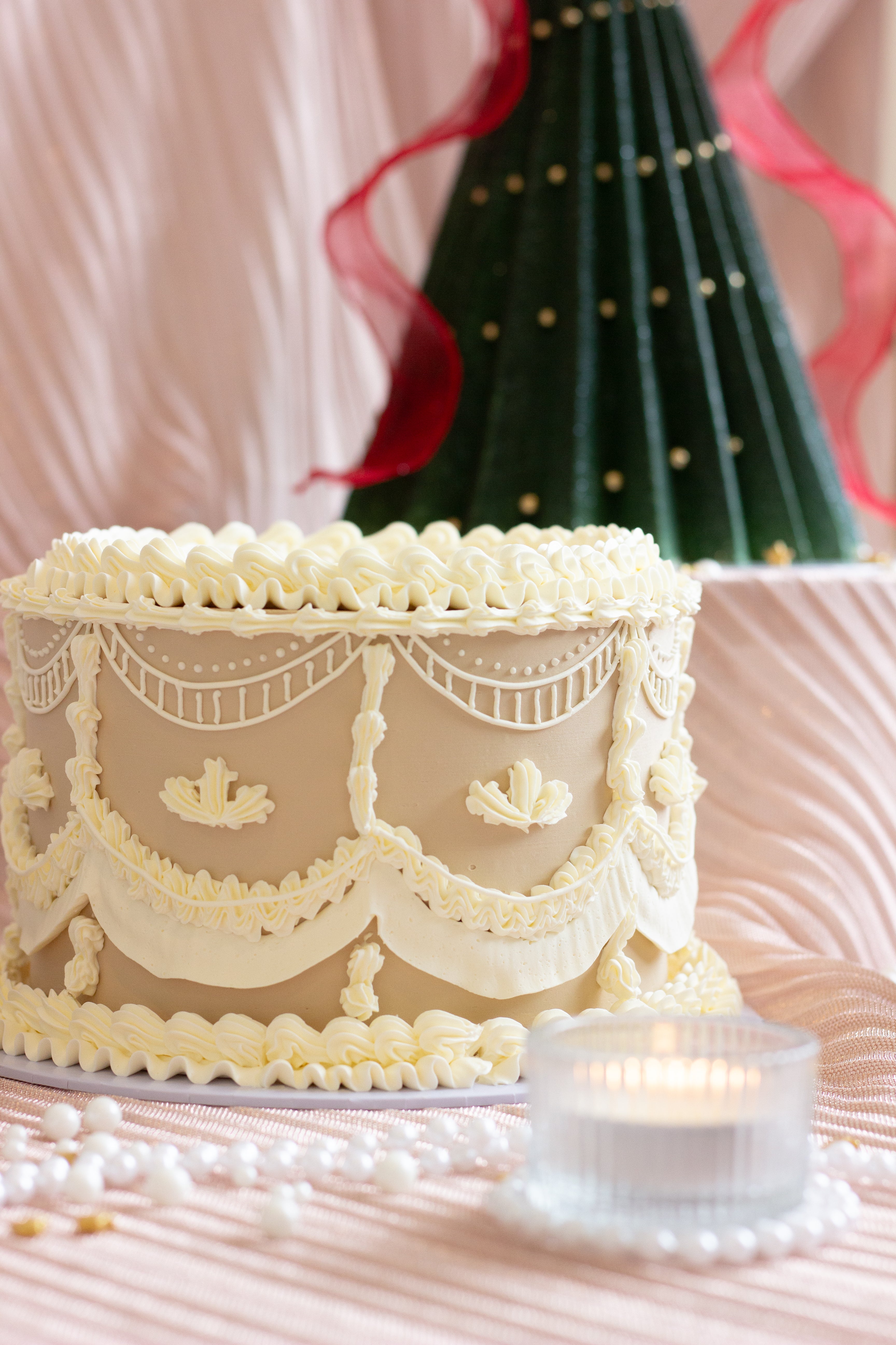 Ivory buttercream cake with detailed vintage piping, swags, and lace style borders. Gingerbread cookie inspired cake. Cake Melbourne